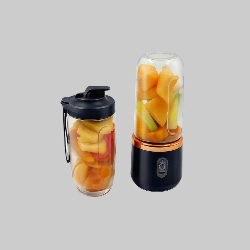 Two portable blenders with fruit inside on a gray background