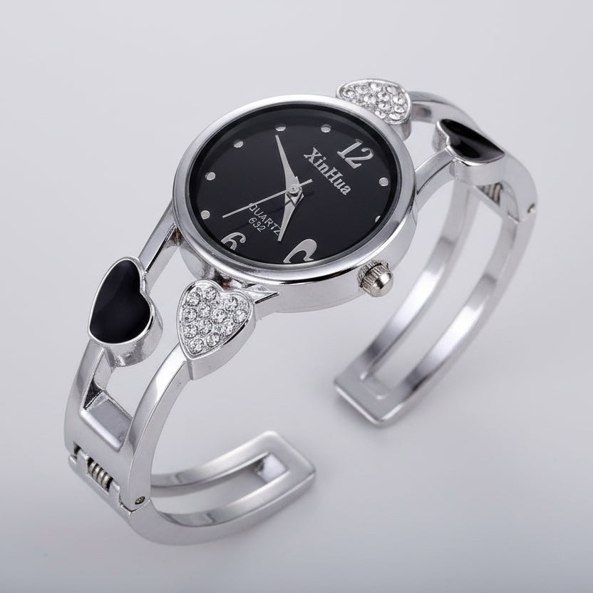 Silver bracelet watch with black dial on a black background