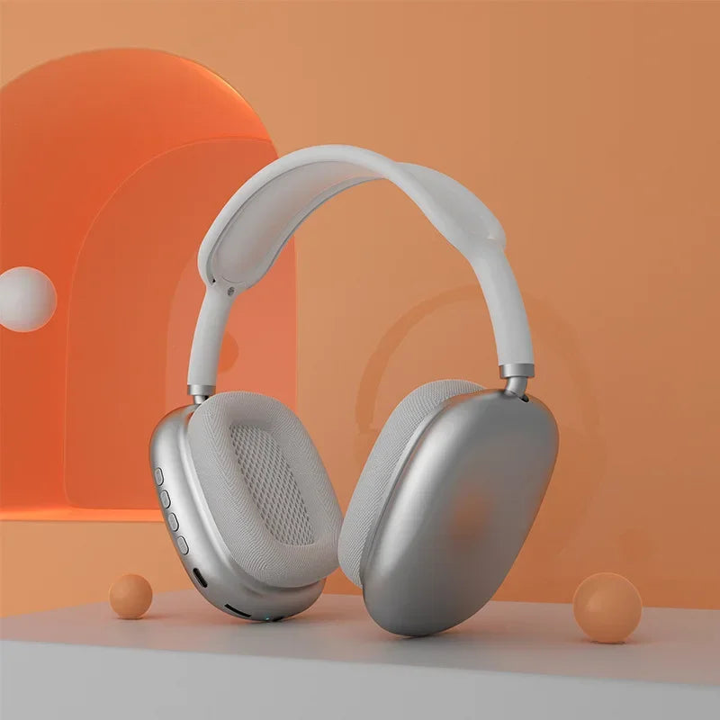Silver headphones on an orange and gray gradient background