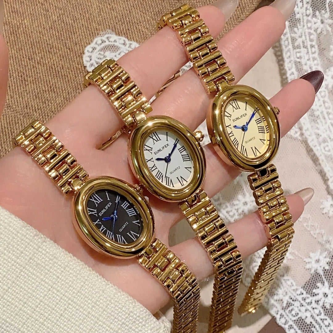 Three gold wristwatches on a hand with a lace background