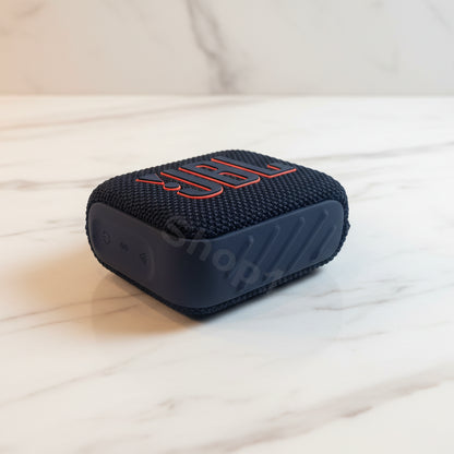 Blue portable speaker with red text on a white background