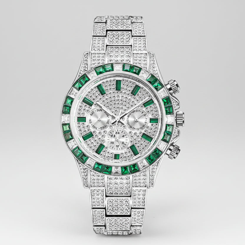 Luxury watch with green gemstones and diamond-studded band on a white background