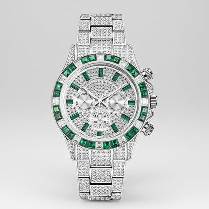 Luxury watch with green gemstones and diamond-studded band on a white background