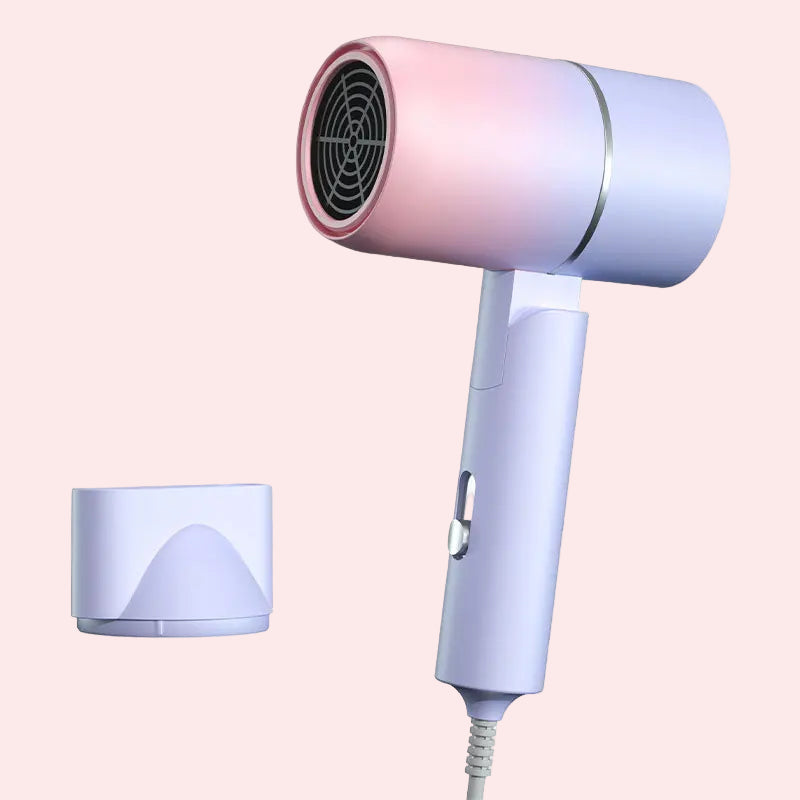 Pink and white hair dryer with a detachable nozzle on a white background