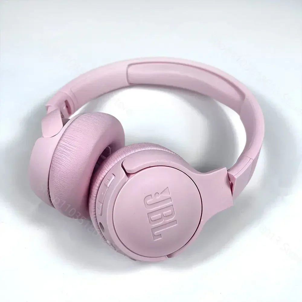 Pink JBL headphones on a light gray background