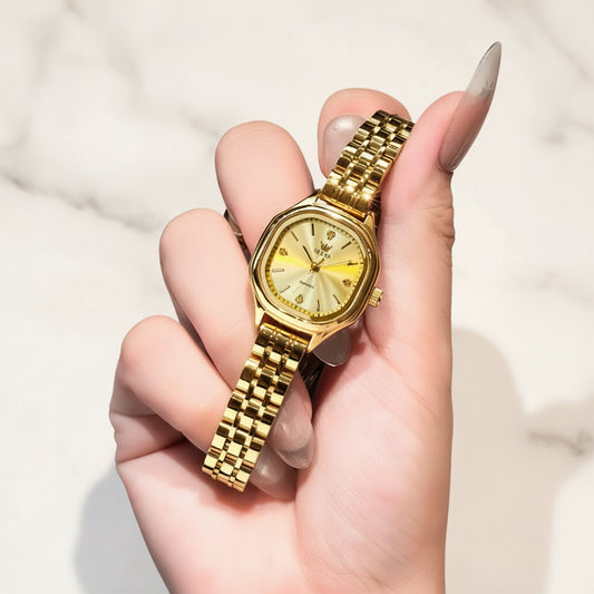Gold watch held in a hand 