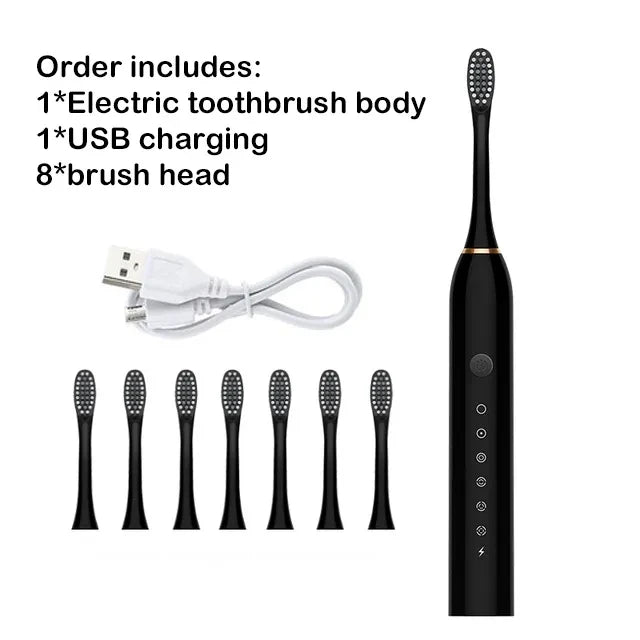 Black electric toothbrush with USB charging cable and multiple brush heads on a white background.