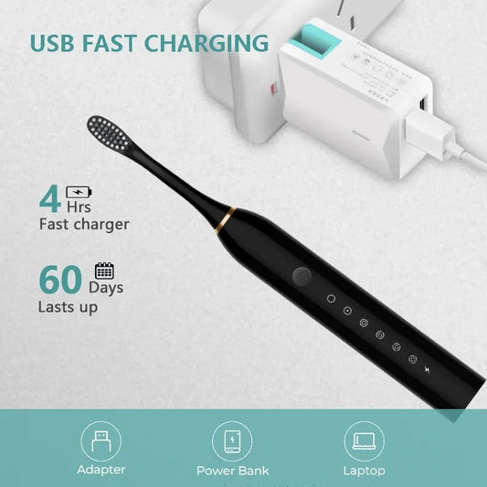 Black electric toothbrush with charging cable and adapter on a light gray background